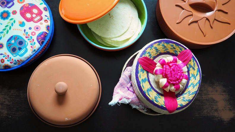 five tortilla warmers on a table