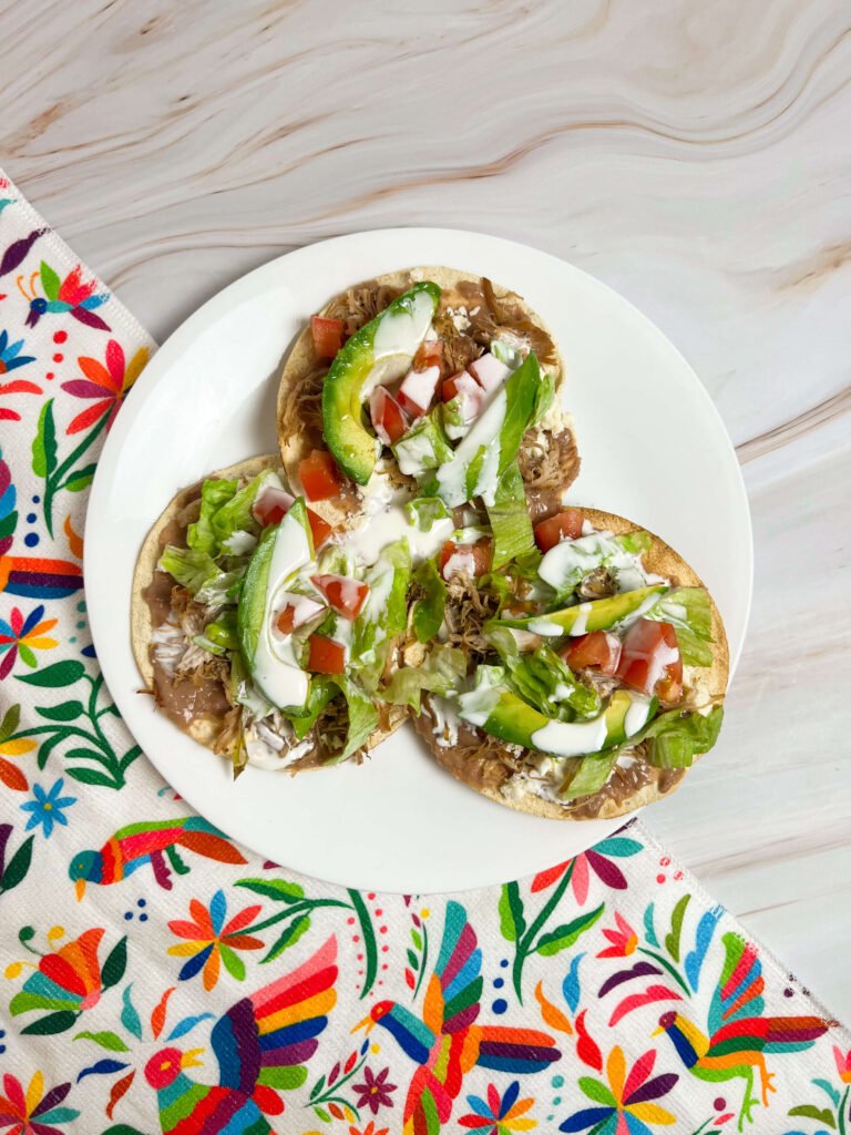 carnitas tostadas topped with vegetables